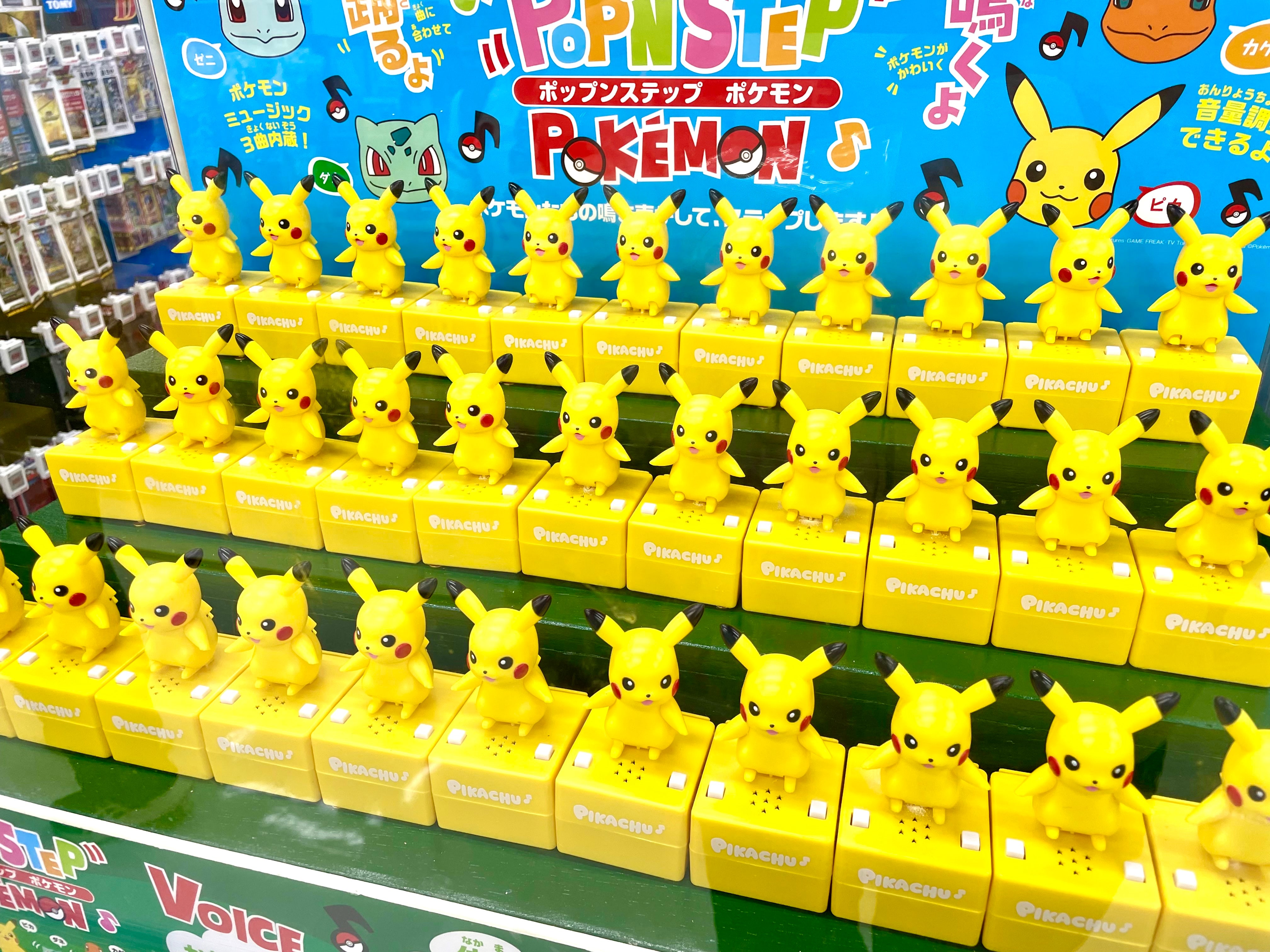 Lots of pikachu figurines in a display case together
